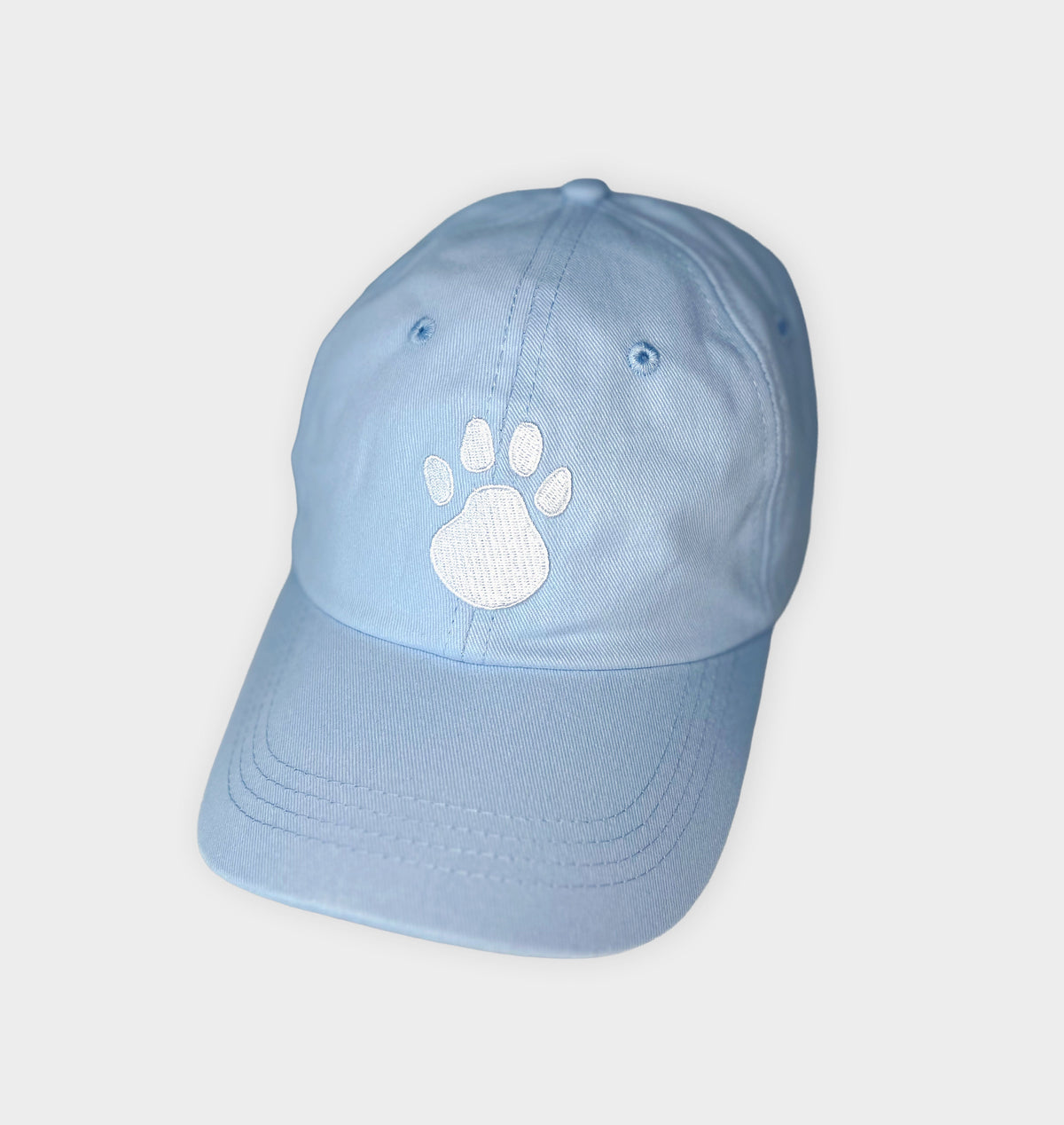 Sky blue baseball cap with white paw print patch on front