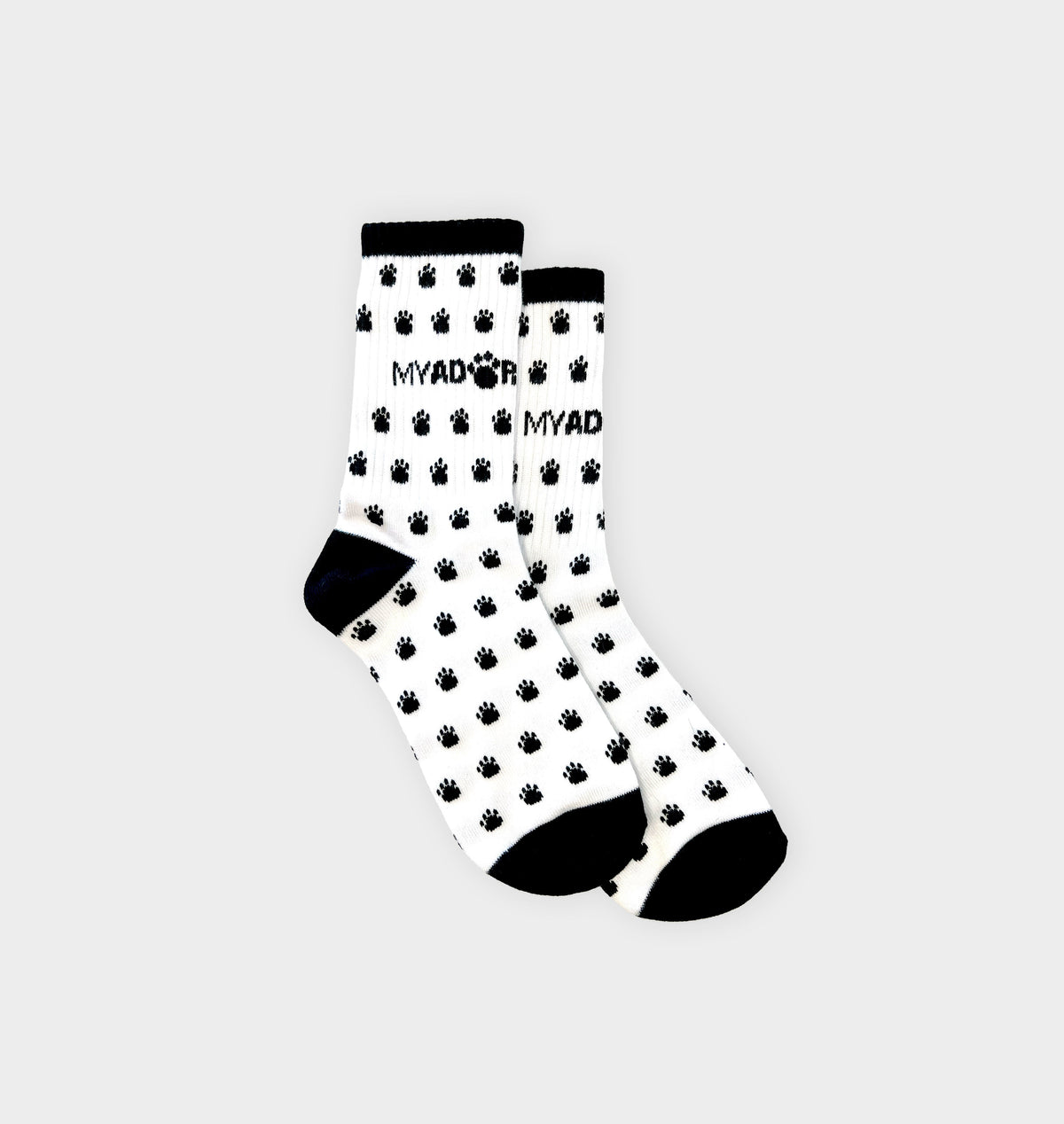 Pair of white crew socks with black paw prints and ribbed black cuffs