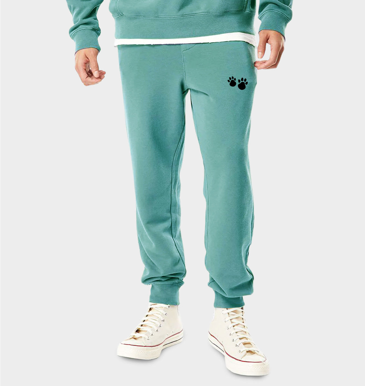 Mint green jogger pants with paw-print logo, cuffed hem