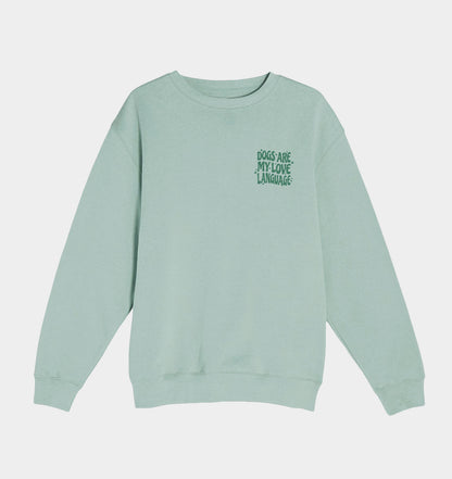 Seafoam green crewneck sweatshirt with small multicolor dog-love graphic on the chest